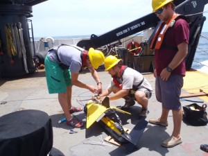 Scientists prepare the sidescan sonar towfish for deployment off the NOAA Ship NANCY FOSTER. Credit: Chris Taylor