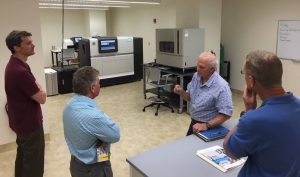 Dr. Val Klump from the University of Wisconsin -Milwaukee School of Freshwater Sciences talks with NOAA team about the school's DNA sequencing lab. 