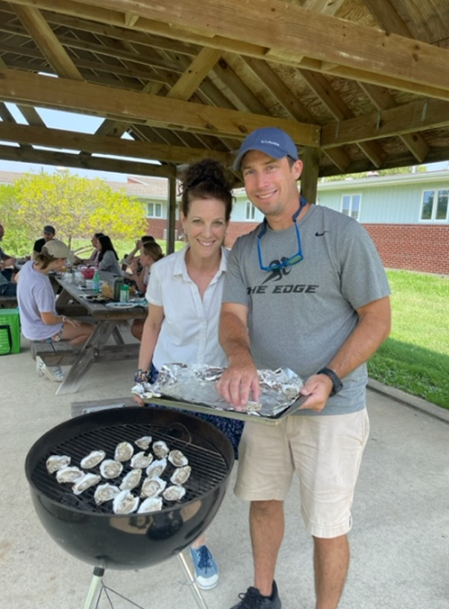 Suzanne Bricker and Jason Spires, leaders of the project to calibrate the FARM model to bottom-grown oysters, show their appreciation to their shucking volunteers by hosting a lunch of grilled oysters purchased from a local oyster grower, July 18, 2023.