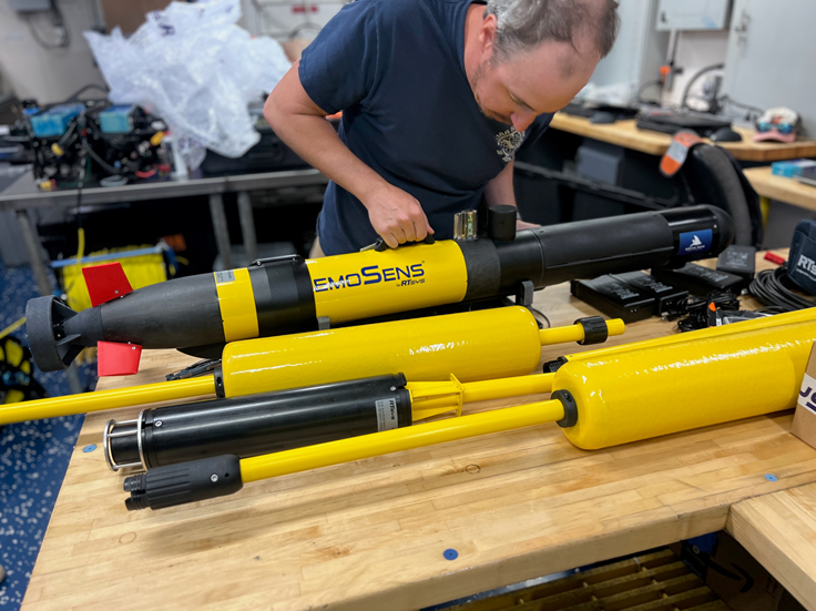 Scientist Mike Bollinger inspects the AUV, a new survey method for the team and a piece of equipment being deployed for the first time on this research cruise. 