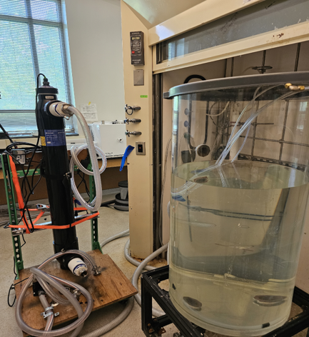 A machine with tubes connected to a tank of clear liquid. 