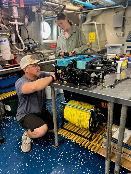 Scientist Erik Ebert and intern Madeleine Gallop work on the remotely operated vehicle — appropriately named “Bluey” — in the wet lab aboard NOAA Ship Nancy Foster.