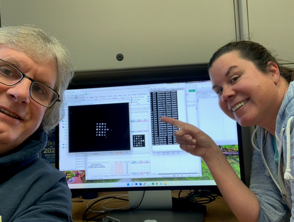 GLERL researchers Duane Gossiaux (left) and Danna Palladino (right) analyze a microcystin array as part of the training. 