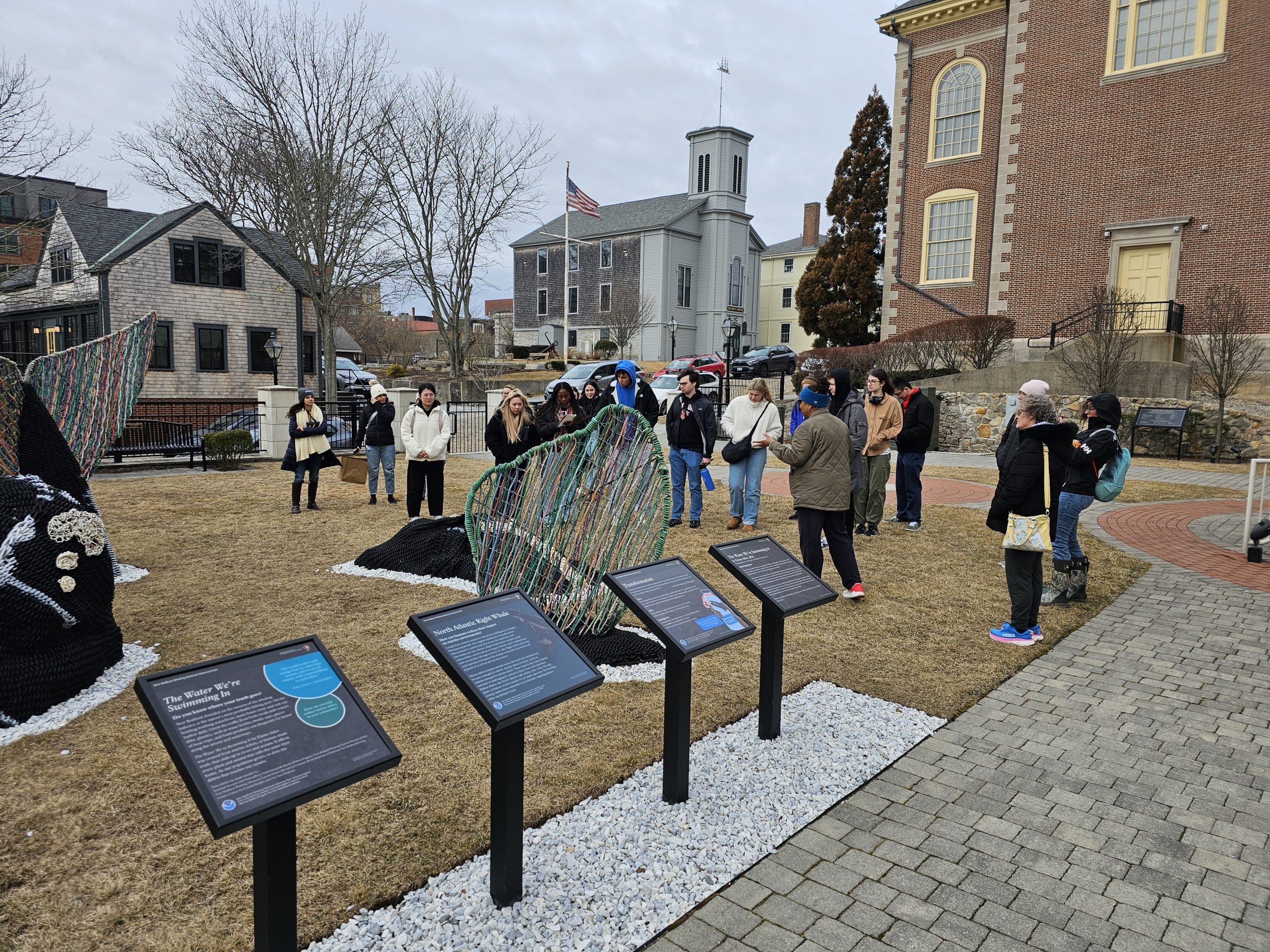 19 people standing in a park